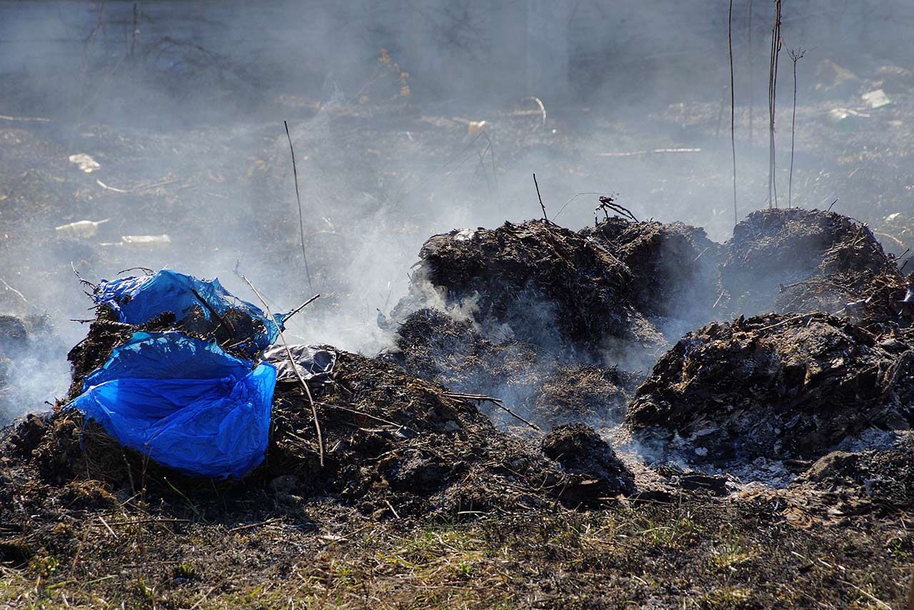 burning rubbish waste pile