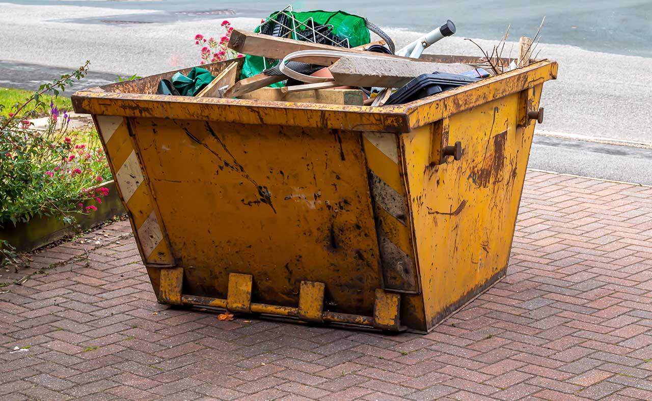 A mini skip on a driveway